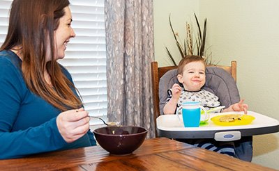 Mother eating with her toddler