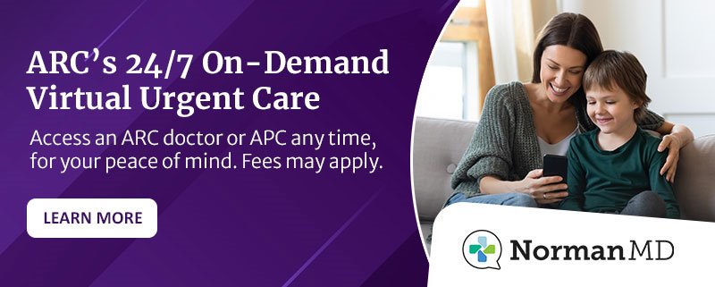 NormanMD ad with the words '24/7 On-Demand Virtual Urgent Care,' 'Access an ARC doctor or APC any time, for your peace of mind. Fees may apply,' 'Learn More' and an image of a mother and son using the NormanMD mobile app while on the couch at home