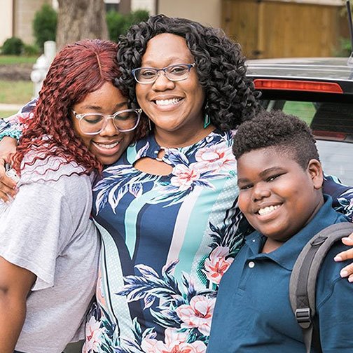 Mother hugging her two children, representing staying ahead and scheduling an appointment