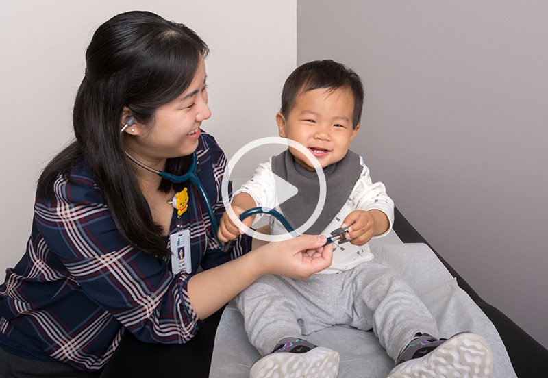 Pediatrician checking a toddler's tummy