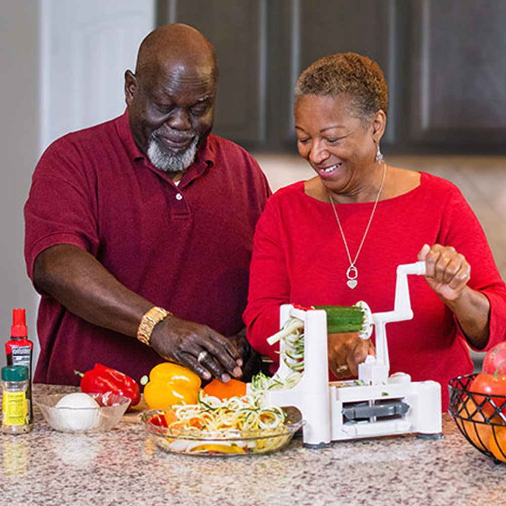Older couple preparing vegetables for a healthy meal that will support their health and weight-loss goals