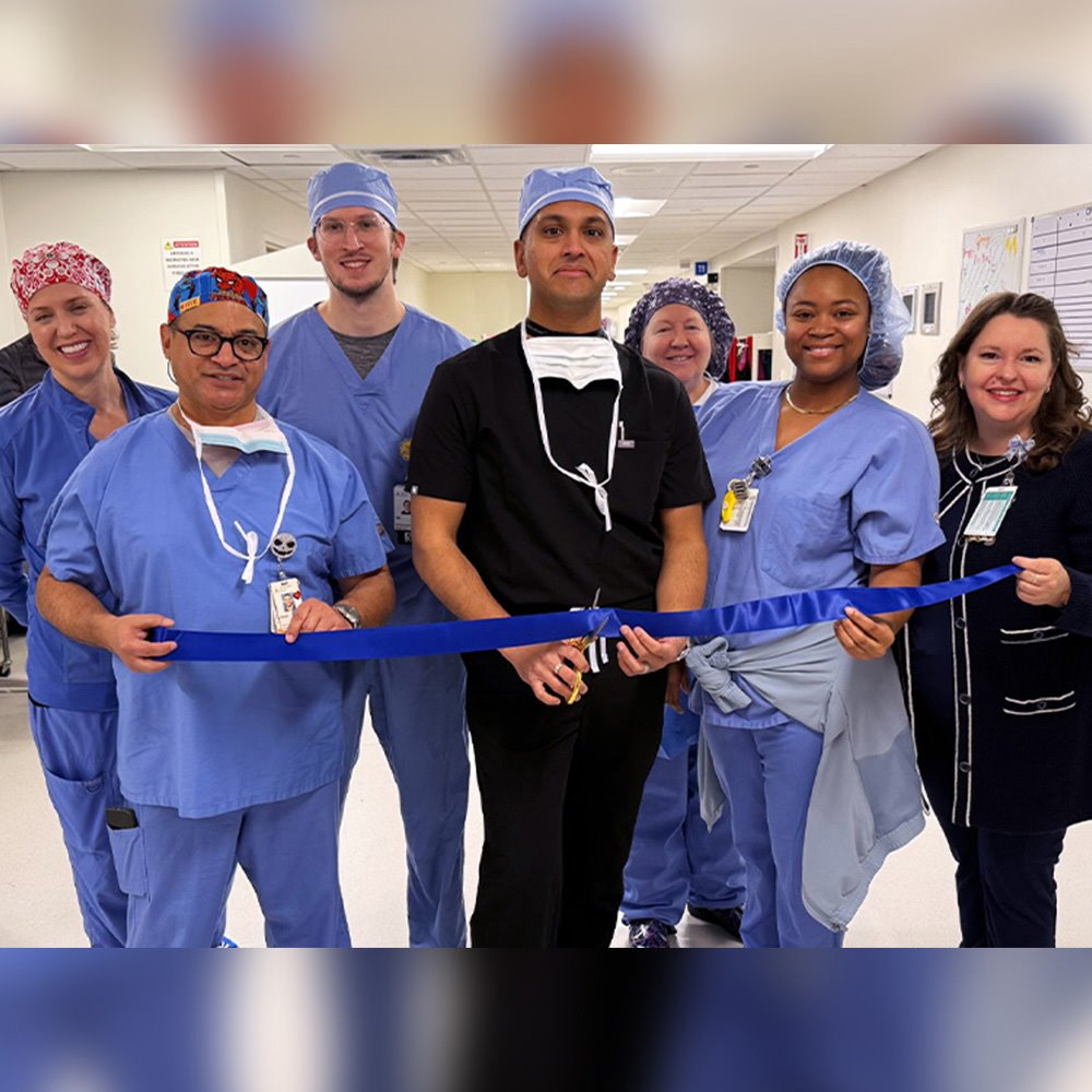 Dr. Akshay Yadhati and his surgical team during a ribbon cutting for Austin's first next-gen robotically navigated Transforaminal Lumbar Interbody Fusion (TLIF)