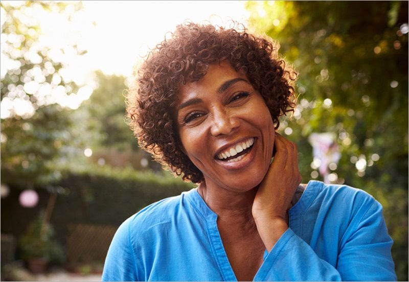 Woman Smiling for Breast Cancer Awareness Month