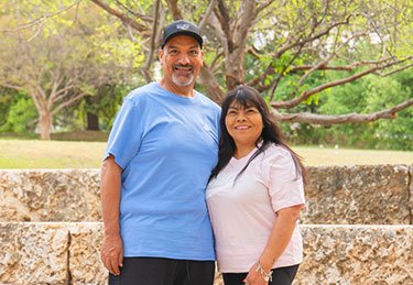 ARC patient and spouse smiling at the camera in an Austin park setting