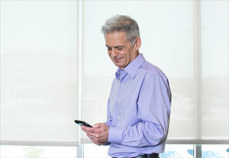 Man using his cell phone for a telehealth doctor appointment