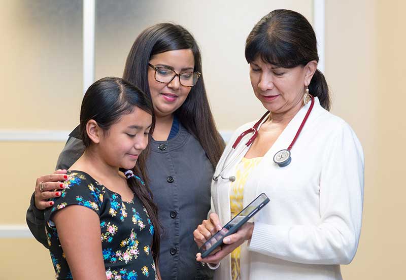 doctor providing value based care for a mom and daughter