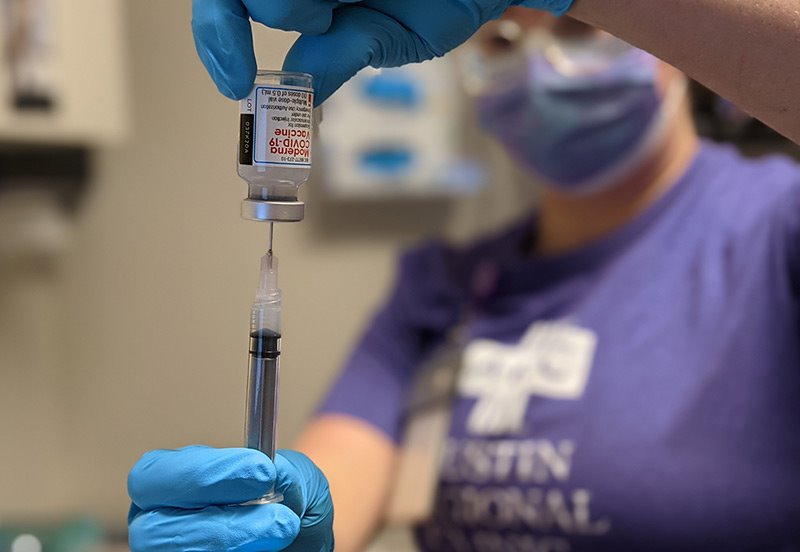 Austin Regional Clinic Nurse preparing a Covid-19 vaccine