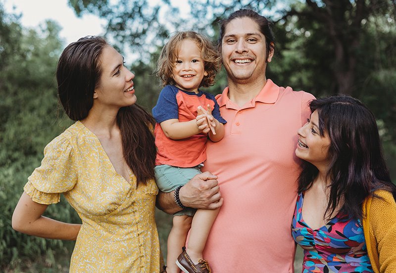 Family of four having a great time outside, representing flu, allergy, cold, and COVID-19 care and prevention