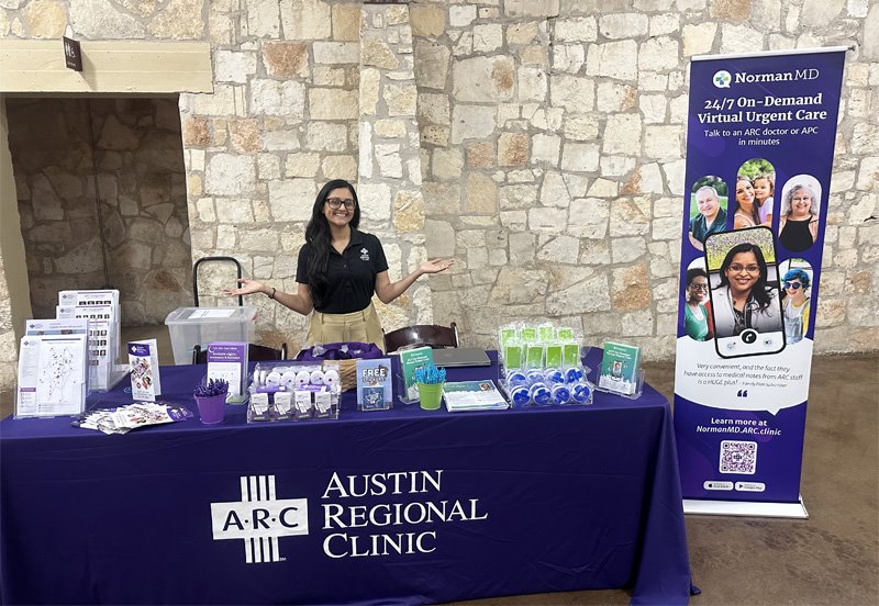 Austin Regional Clinic team member behind an ARC booth at the City of Georgetown Biometrics Event