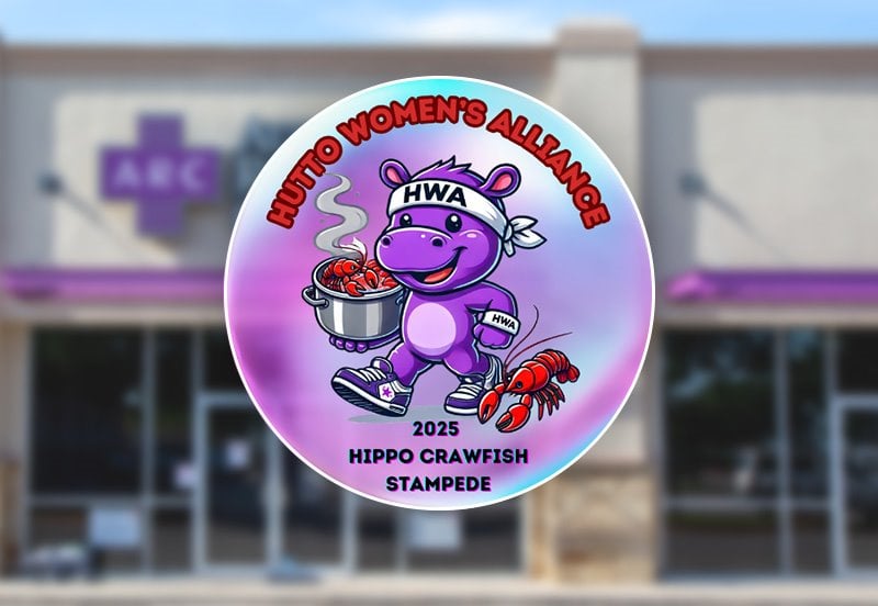 Logo for the 2025 Hippo Crawfish Stampede event by the Hutto Women's Alliance with a blurred view of the ARC Hutto clinic in the background