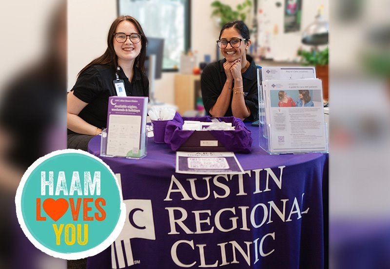 Two Austin Regional Clinic team members sitting down at the ARC booth during the 2026 HAAM Loves You event in Austin