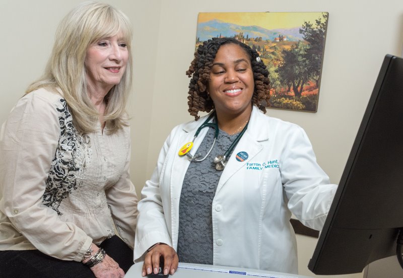 Austin Regional Clinic doctor looking at test results with a patient