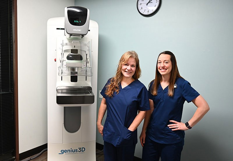 Two ARC mammography technicians next to a mammography machine at ARC Far West in Austin