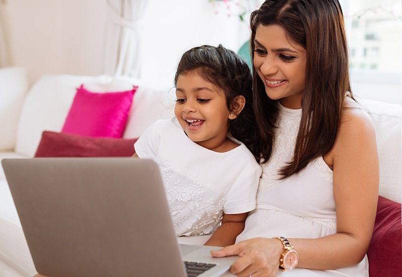 Mom and daughter on the computer using the Austin Regional Clinic Website