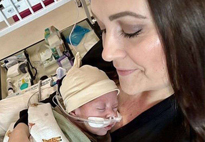 Mother holding her baby while at the hospital