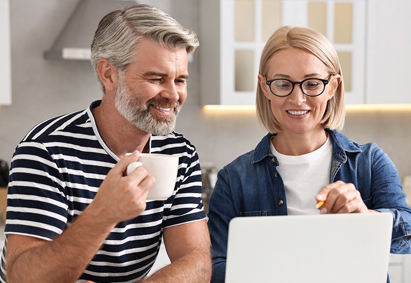 Couple using a laptop to update their health information online