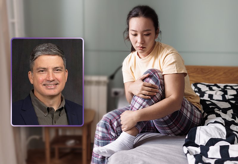 Young woman sitting up on the edge of her bed while holding on to her left leg, representing discomfort caused by restless legs syndrome (RLS), and an image of Christopher K. Darnall, MD, Neurologist at ARC