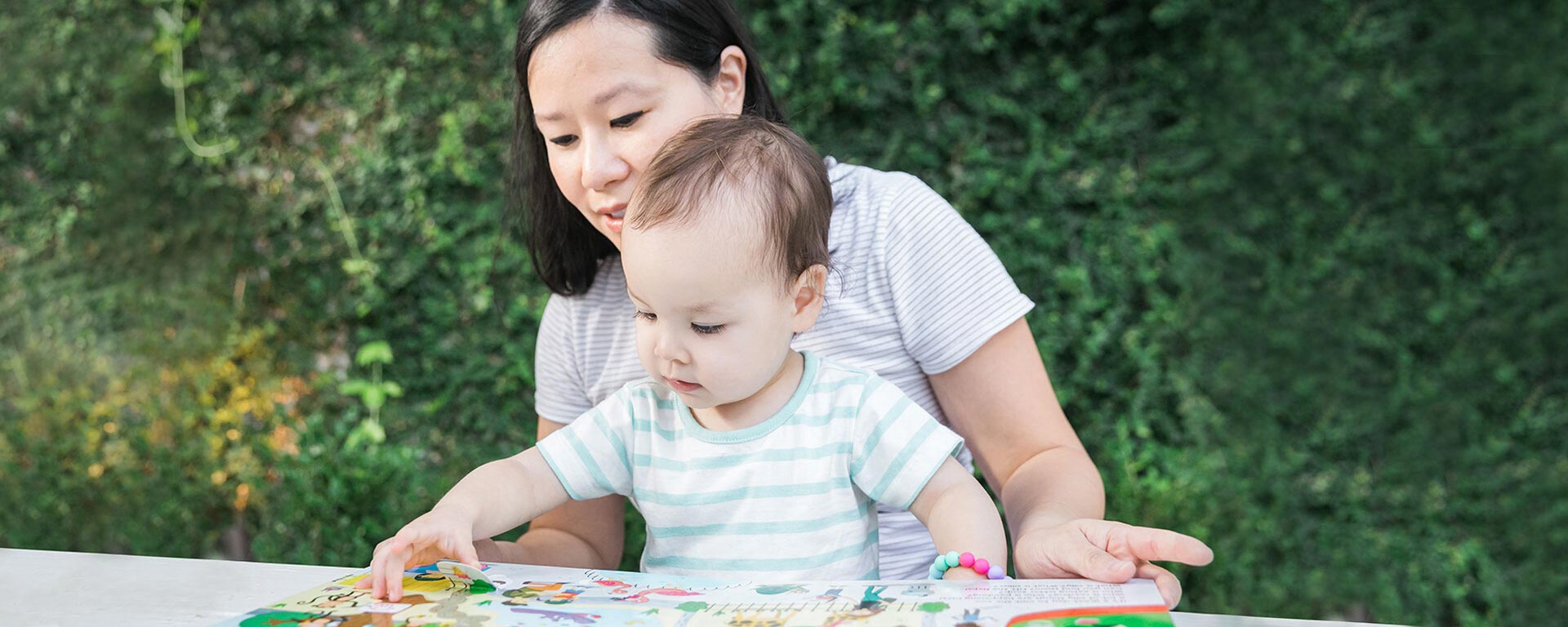 Mother and child interacting with a story book